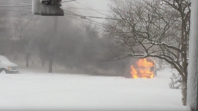 VIDEO: Car bursts into flames as it struggles to drive up snow covered hill