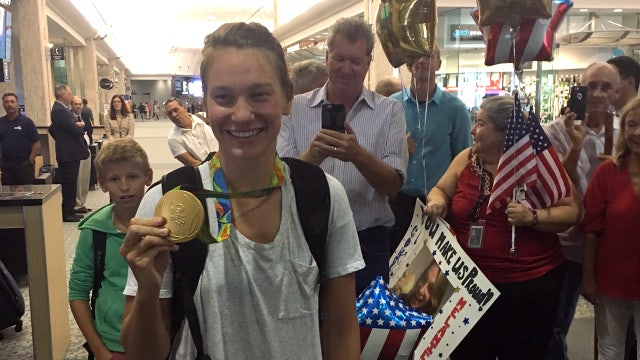 Cheers, hugs as Olympic gold medalist returns home