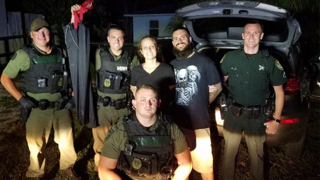 Smiling Florida couple pose with deputies after their arrest