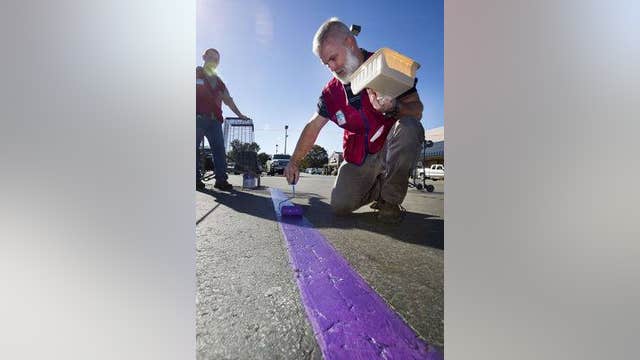Volunteers honor wounded vets with purple parking spaces