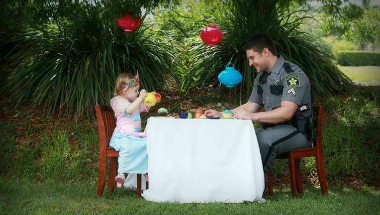 96f6d912-Deputy and daughter sit down to tea