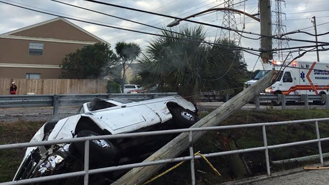 Driver hospitalized after crash snaps power pole in half