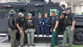 SWAT officers surprise boy hit by truck on Halloween