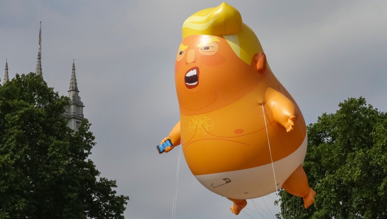 A giant baby trump balloon flies over the Parliament Square in London, United Kingdom during a demonstration against the visit to the UK by US President Donald Trump