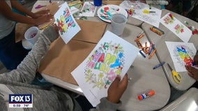 Children decorate holiday donation bags for the homeless