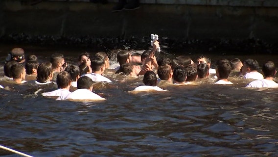 Spectators moved online for annual Epiphany celebration dive