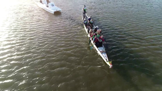 Breast cancer survivors on this dragon boat paddling team stay in sync together