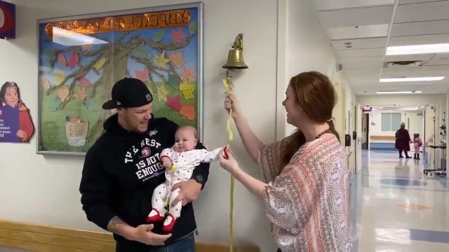Mom helps infant daughter ring bell after beating brain cancer