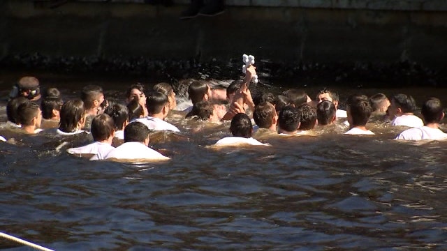 Spectators moved online for annual Epiphany celebration dive