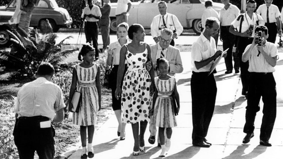 Mother escorts her two daughters to Orchard Villa School