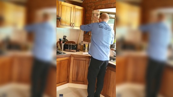 Family finds venomous snake curled up behind toaster