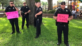 Officer holds 'free hugs' sign during peaceful protests in Polk County