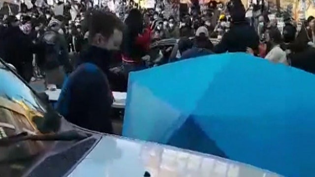 Man shot after suspect drives car through crowd of protesters in Seattle, authorities say