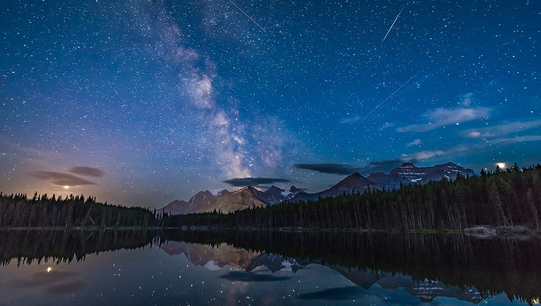 b66a1b5b-The view looking south at Herbert Lake, Banff National Park, Alberta, with the Milky Way over Mount Temple. Jupiter flanks the Milky Way on the right, while Saturn sits within the Milky Way.
