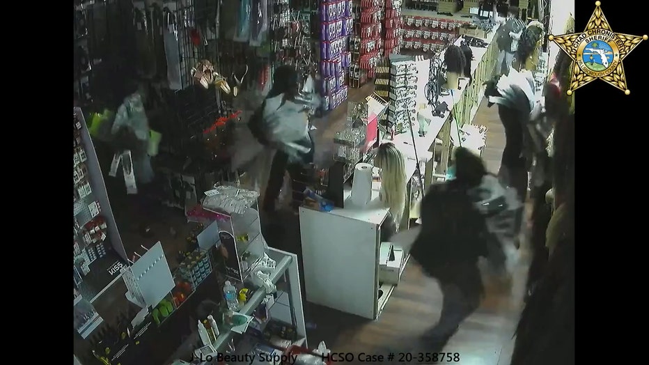 Looters storm through broken glass doors of beauty supply store