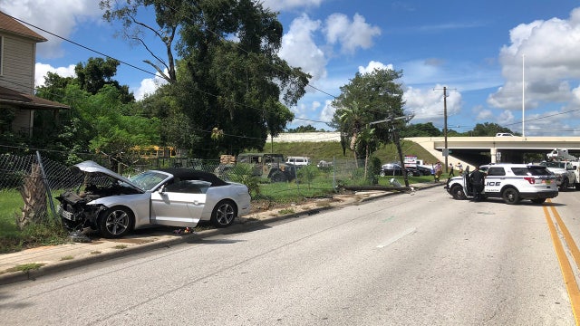 Bystander pinned after car crashed into TECO power pole, officials say