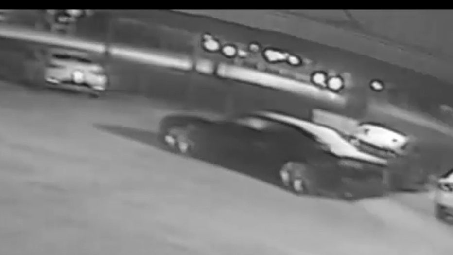 surveillance photo of car being taken from car lot