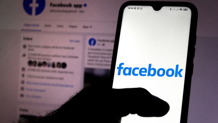 FILE - In this photo illustration a Facebook logo seen displayed on a smartphone. 