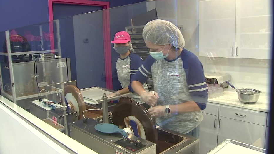 Mother and daughter working in chocolate shop