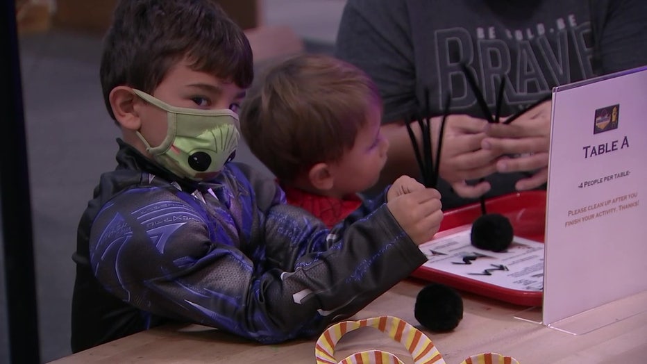 Boy in superhero outfit making a spider
