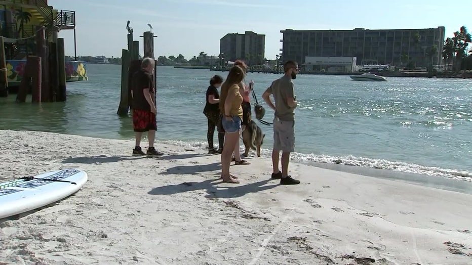 People standing on sand build-up