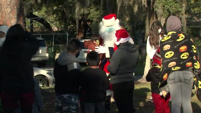 Santa makes early stop in Bradenton, hands out presents, food to families in need