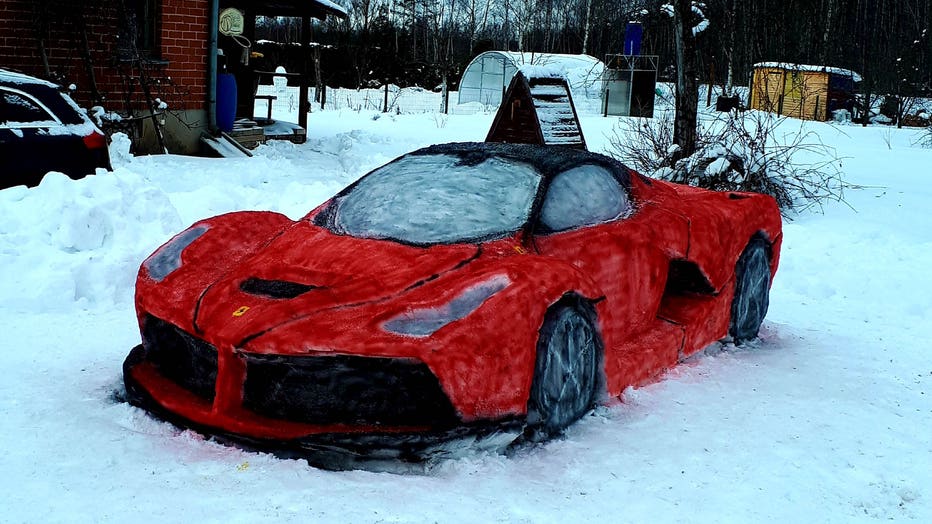 Couple carves their own life-size red Ferrari out of snow