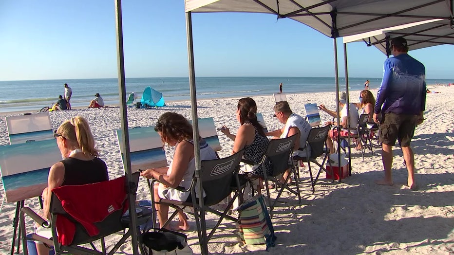 Beach art class helps participants relax by painting picture