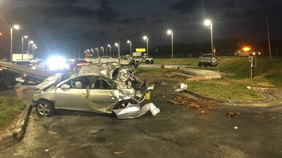 PHOTOS: Driver charged after box truck smashes into car dealership
