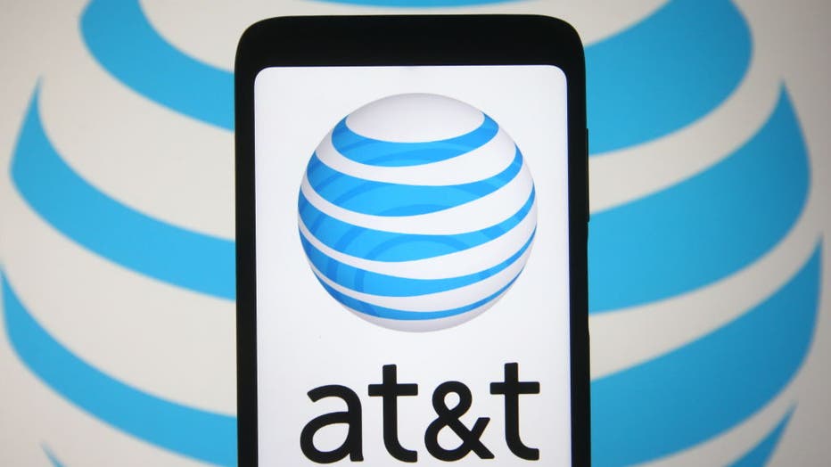 In this photo illustration the AT&T logo is seen on a