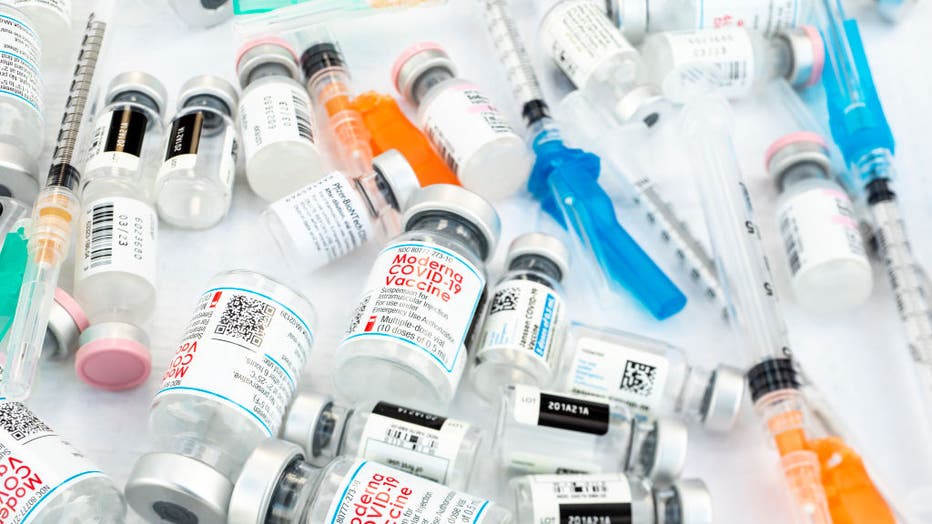 Bottles of the three current COVID-19 vaccines from Johnson & Johnson, Moderna and Pfizer, with hypodermics needles