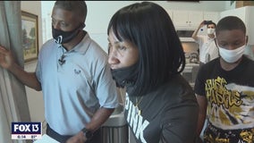 Two families move into new homes, thanks to former Buc Warrick Dunn