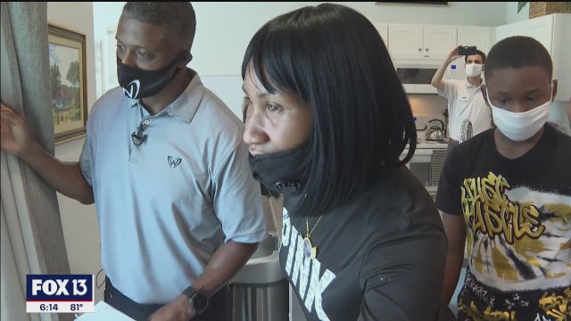 Two families move into new homes, thanks to former Buc Warrick Dunn