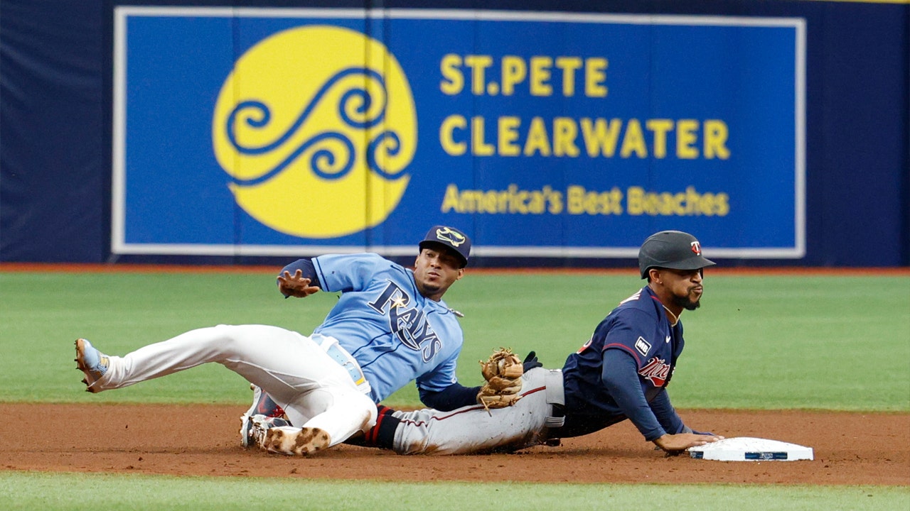 Willians Astudillo takes off his hat to catch a pop-up with his