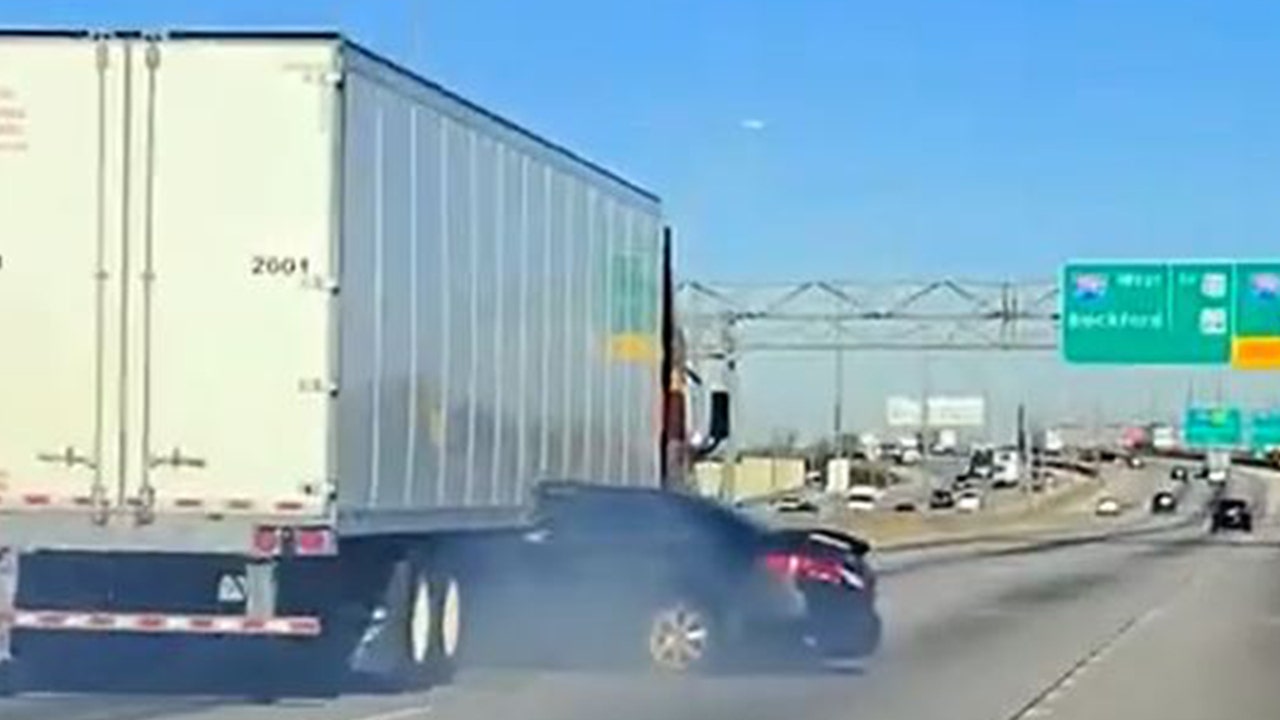 shocking video shows semi truck dragging car down illinois highway