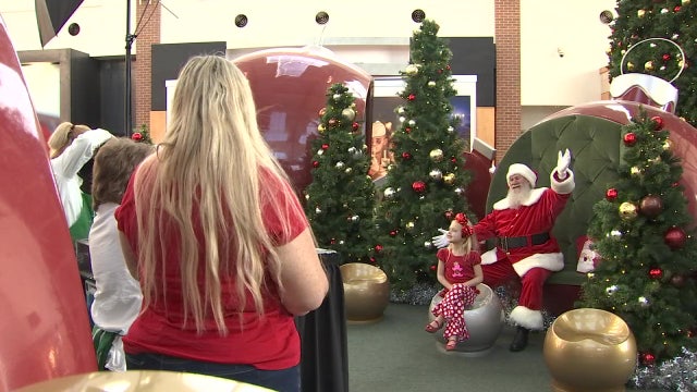 After a year away, Santa is back in town posing for pictures, listening to wish lists