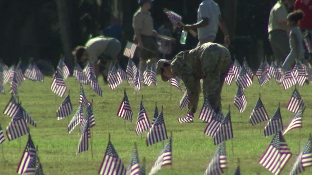 Volunteers place more than 25,000 flags at Bay Pines National Cemetery ahead of Memorial Day