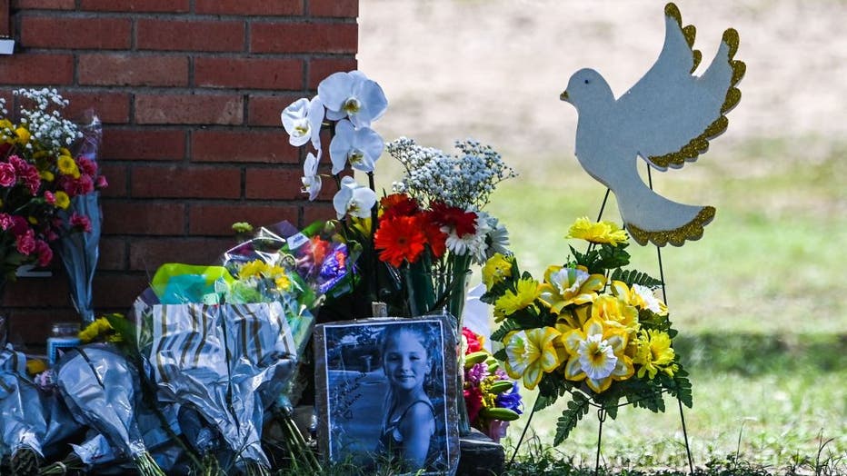 The photo of Makenna Lee Elrod, a little girl victim of the shooting, is seen by flowers placed on a makeshift memorial in front of Robb Elementary School in Uvalde, Texas, on May 25, 2022. (Photo by CHANDAN KHANNA/AFP via Getty Images)