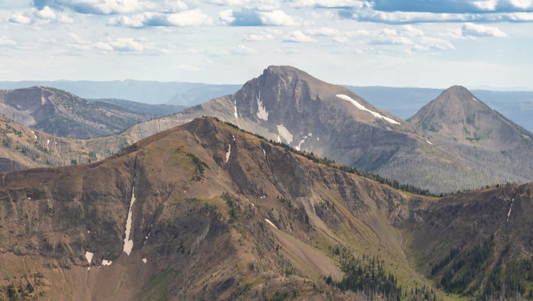First Peoples Mountain (center) rises between Top Notch Peak (foreground) and Mt. Stevenson (back right) seen from Avalanche Peak.