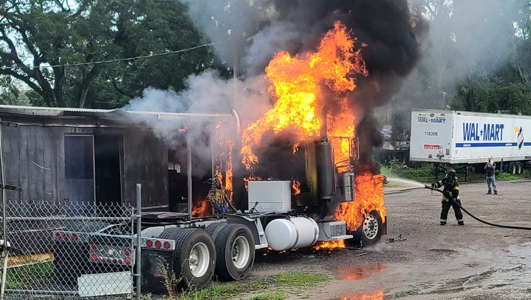 Semi-truck and mobile home on fire.
