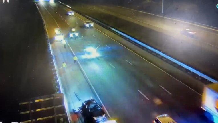 Photo: First responders patrol vehicle block traffic on I-75, victim's vehicle is seen in outside lane