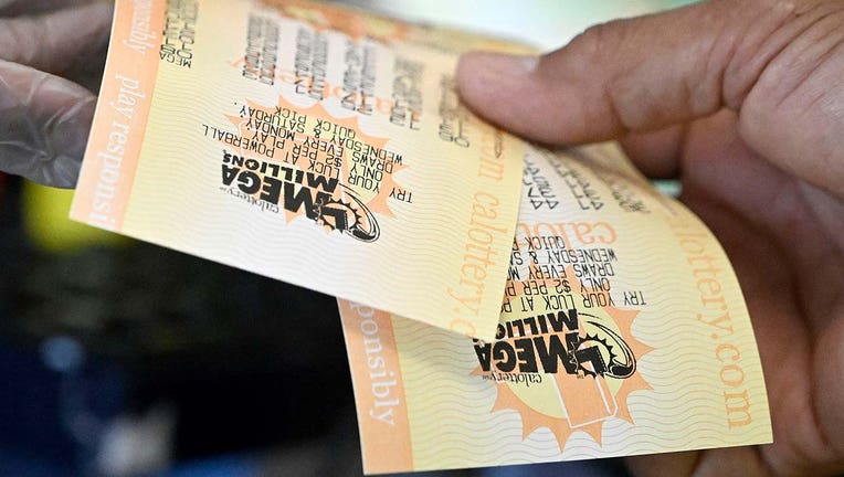 Photo: Person holds two Mega Million tickets