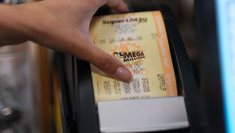 Photo: A cashier prints out a Mega Millions lottery ticket at a 7-Eleven convenience store in Chino Hills, California