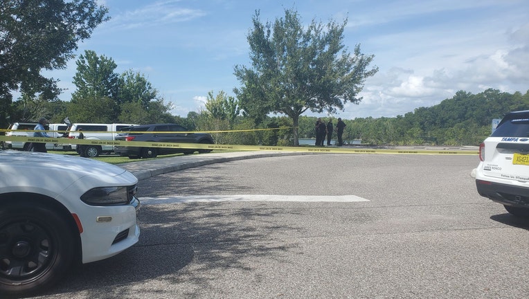 Police vehicle and crime scene tape around dock in Grand Hampton neighborhood where a man's body was found. 