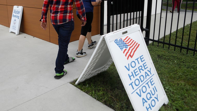 Voters prepare to cast their voting ballot at the C. Blythe Andrews, Jr. Public Library - Getty