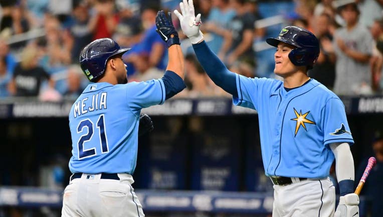 Francisco Mejia #21 of the Tampa Bay Rays celebrates with Yu Chang #9 after hitting a home run in the sixth inning against the Baltimore Orioles at Tropicana Field on July 17, 2022 in St Petersburg, Florida.
