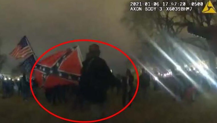 Photo: David Alan Blair seen in an officer's body cam video with a Confederate flag on Jan. 6, 2021. 