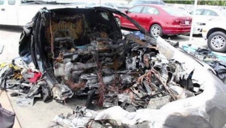 Photo: The charred Tesla involved in the crash that killed Barrett Riley and Edgar Martinez