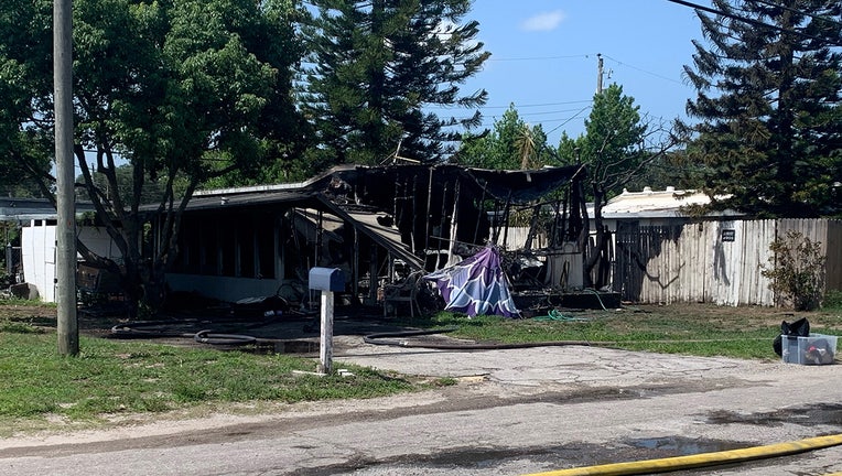 Photo: Mobile home heavily damaged after fire in Holiday, Florida.
