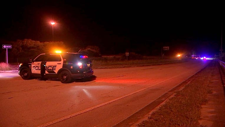 Photo: Lakeland police cruiser at nighttime with activated lights, blocking roadway where fatal crash occurred.